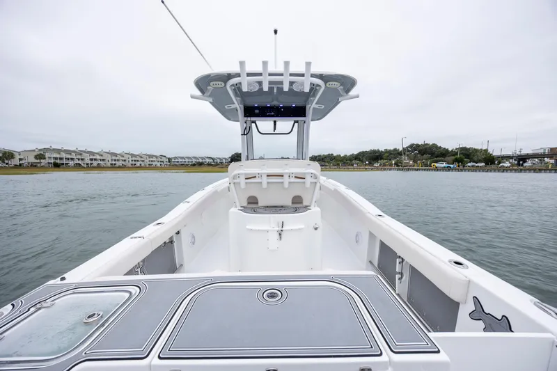 Slide: The Image of 2021 Sea Hunt Gamefish 25 boat on water, showcasing spacious deck and modern design. - 18