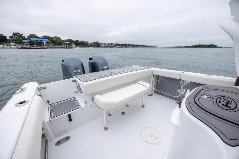 Slide: The Image of 2021 Sea Hunt Gamefish 25 boat with dual engines on a calm waterway. - 19