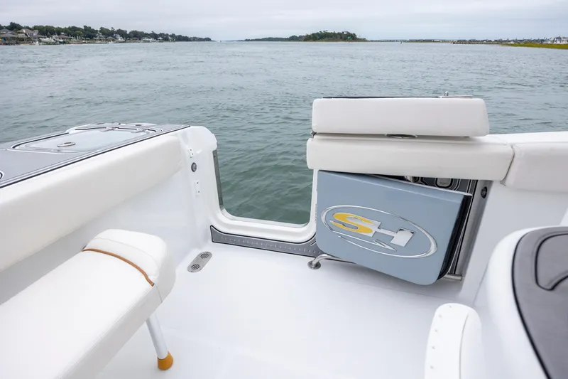 Slide: The Image of 2021 Sea Hunt Gamefish 25 boat interior with open side door, overlooking calm waters. - 20