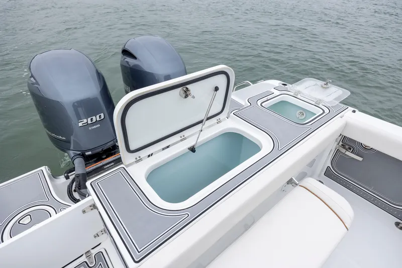 Slide: The Image of 2021 Sea Hunt Gamefish 25 boat with Yamaha 200 engines and open storage compartments. - 21