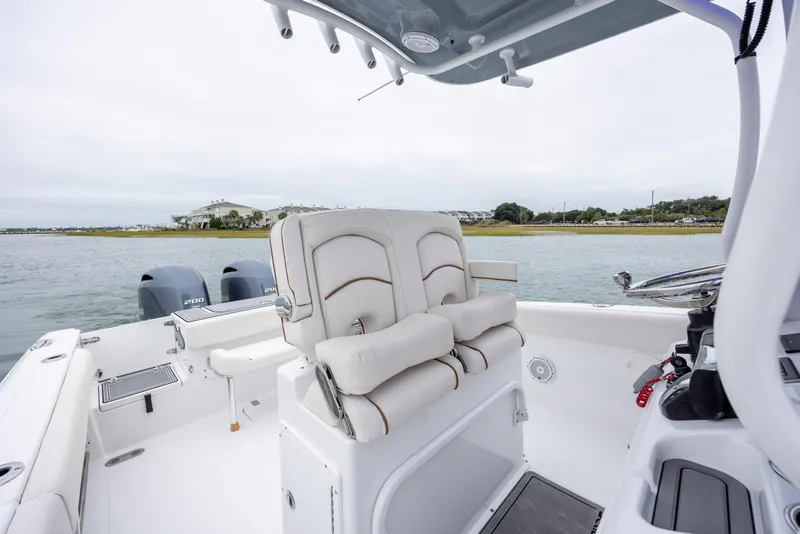 Slide: The Image of 2021 Sea Hunt Gamefish 25 boat interior with dual engines, on calm water. - 26