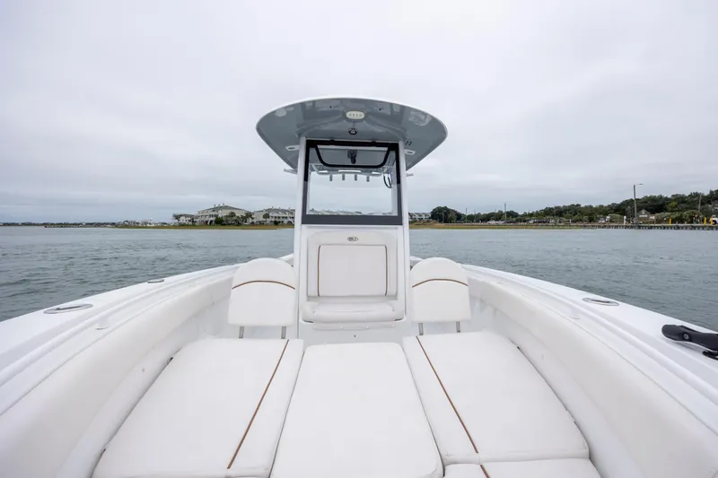 Slide: The Image of 2021 Sea Hunt Gamefish 25 boat with white seating, on calm waters. - 30