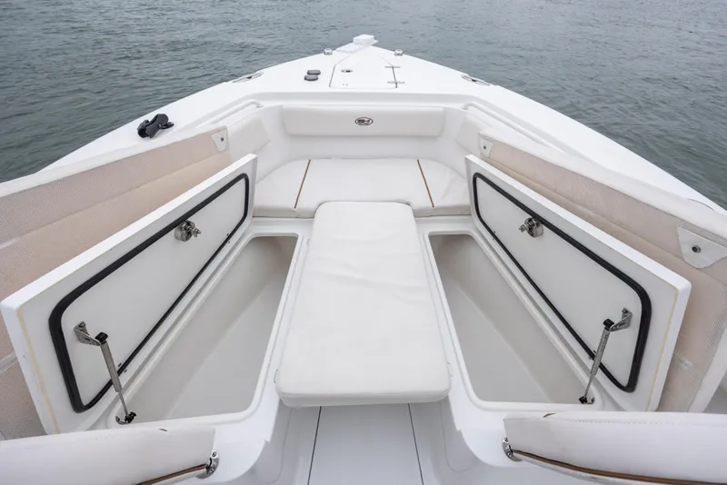 Slide: The Image of 2021 Sea Hunt Gamefish 25 boat interior with open storage compartments and cushioned seating. - 31