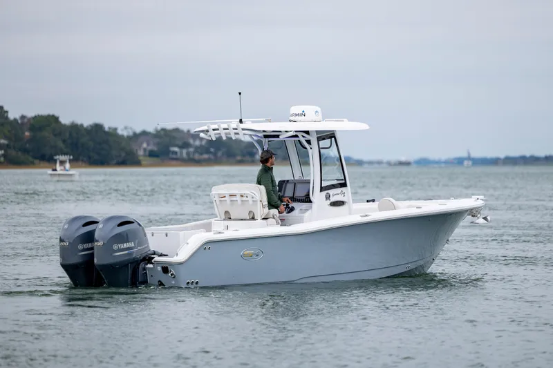 Slide: The Image of 2021 Sea Hunt Gamefish 25 boat with dual Yamaha engines on calm water. - 5
