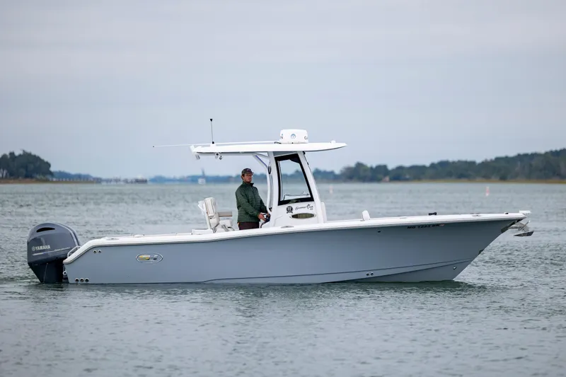 Slide: The Image of 2021 Sea Hunt Gamefish 25 boat on calm water with Yamaha engine. - 6