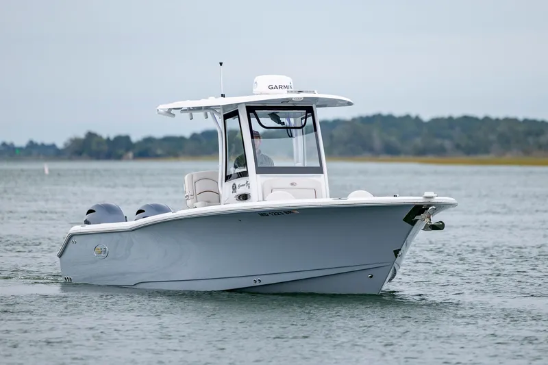 Slide: The Image of 2021 Sea Hunt Gamefish 25 boat cruising on calm waters. - 7