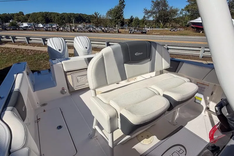 Slide: The Image of 2024 Robalo R250 Center Console boat with dual engines and cushioned seating. - 5