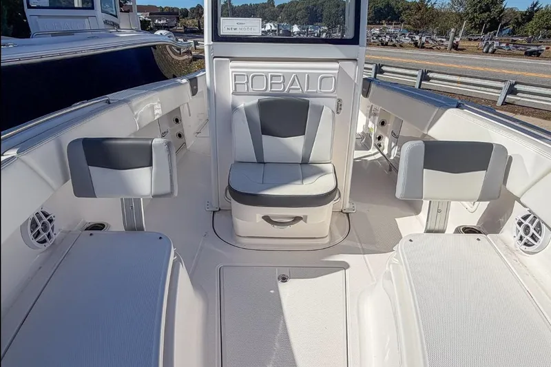 Slide: The Image of 2024 Robalo R250 Center Console boat interior with seating and storage. - 7