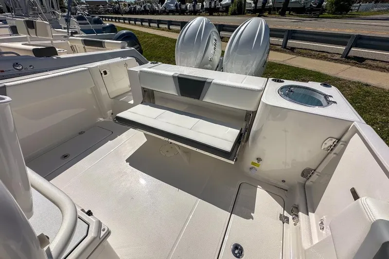 Slide: The Image of 2024 Robalo R250 Center Console boat interior with seating and twin engines. - 9
