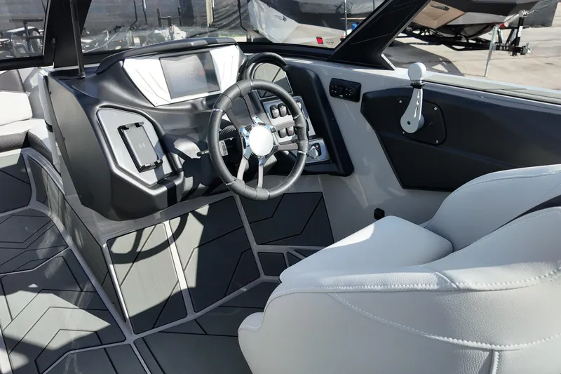 Slide: The Image of Interior of 2025 Supreme S220 boat, featuring modern dashboard and steering wheel design. - 11