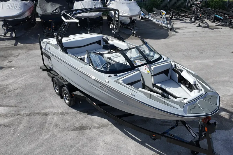 Slide: The Image of 2025 Supreme S220 boat on trailer, sleek design, parked outdoors. - 29