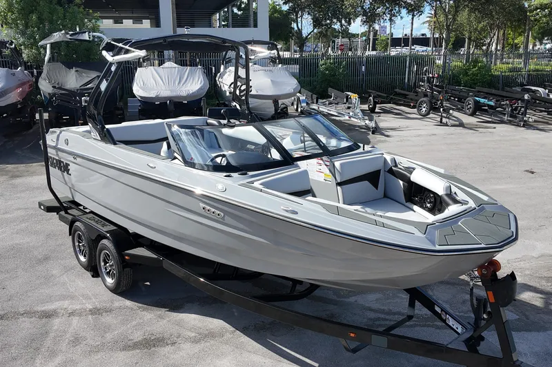 Slide: The Image of 2025 Supreme S220 boat on trailer, sleek design, parked outdoors. - 5
