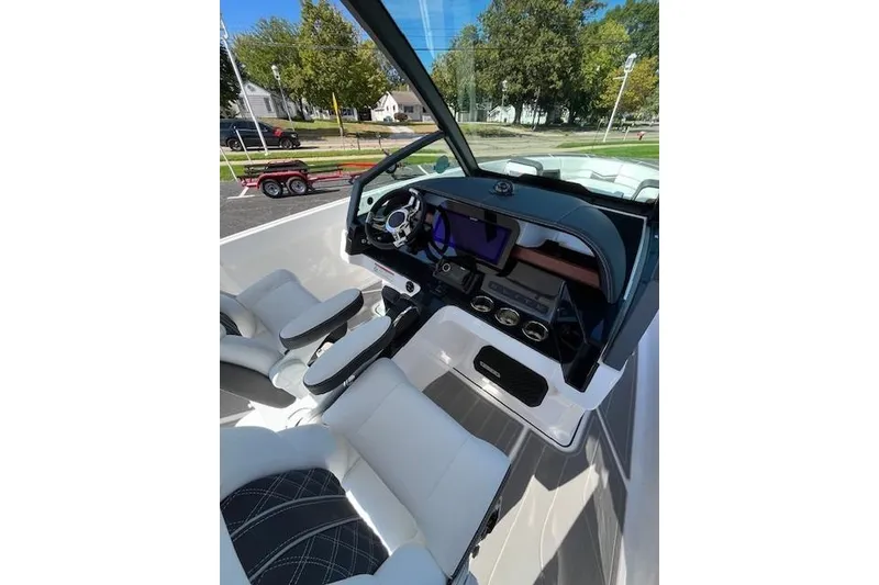 Slide: The Image of 2026 Monterey Elite 27 SD boat interior with modern dashboard and comfortable seating. - 10