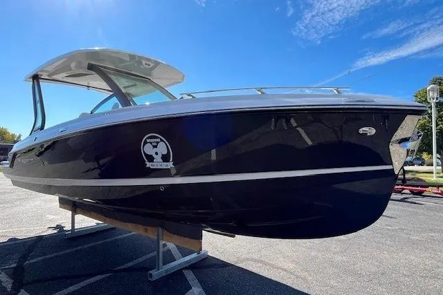 Slide: The Image of 2026 Monterey Elite 27 SD boat on display under clear blue sky. - 2