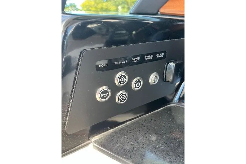 Slide: The Image of Control panel of 2026 Monterey Elite 27 SD boat with labeled buttons and switches. - 24