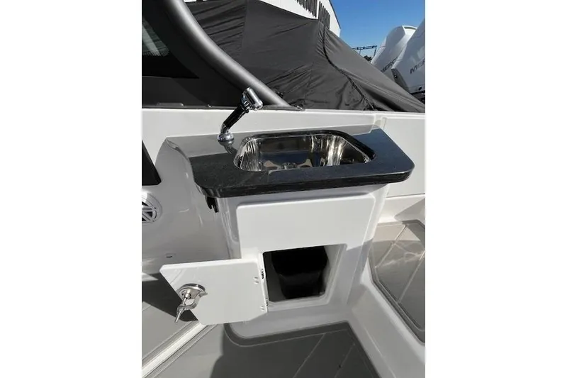 Slide: The Image of 2026 Monterey Elite 27 SD boat sink with storage compartment and sleek design. - 25