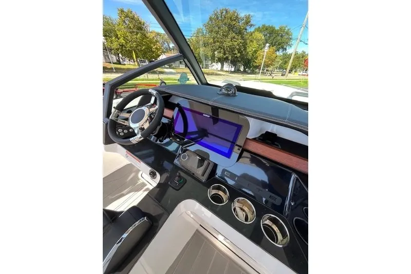 Slide: The Image of 2026 Monterey Elite 27 SD boat dashboard with modern steering and digital display. - 8