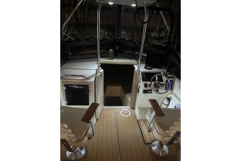 Slide: The Image of 1994 Albemarle Sportfish boat interior with helm, seating, and wooden flooring. - 10