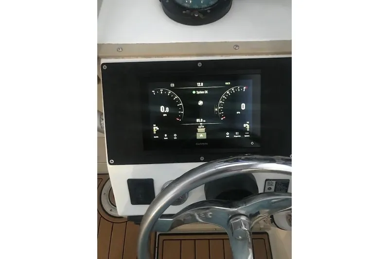Slide: The Image of 1994 Albemarle Sportfish dashboard with Garmin display and steering wheel. - 12