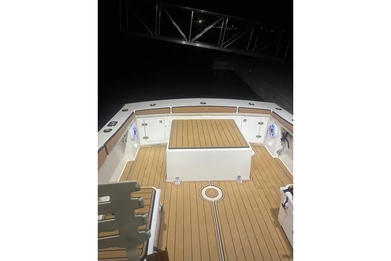 Slide: The Image of 1994 Albemarle Sportfish boat deck with wood finish, illuminated at night. - 2