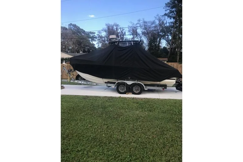Slide: The Image of 1994 Albemarle Sportfish boat covered on trailer, parked in driveway. - 21