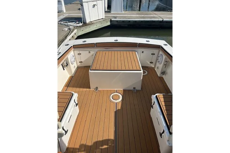 Slide: The Image of 1994 Albemarle Sportfish boat deck with teak flooring and storage compartments. - 7