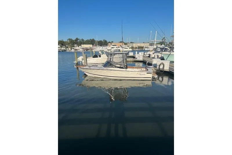 Slide: The Image of 1994 Albemarle Sportfish boat docked in a marina under clear blue skies. - 11