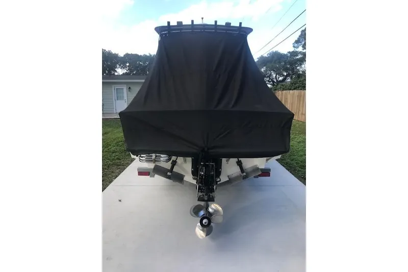 Slide: The Image of 1994 Albemarle Sportfish boat with black cover, rear view, on trailer. - 17