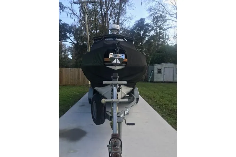 Slide: The Image of 1994 Albemarle Sportfish boat on trailer, covered, parked in driveway. - 22