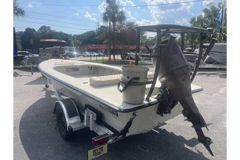 Slide: The Image of 2026 Delta Boatworks Delta D-18 Tiller on trailer, displayed at a boat dealership. - 19