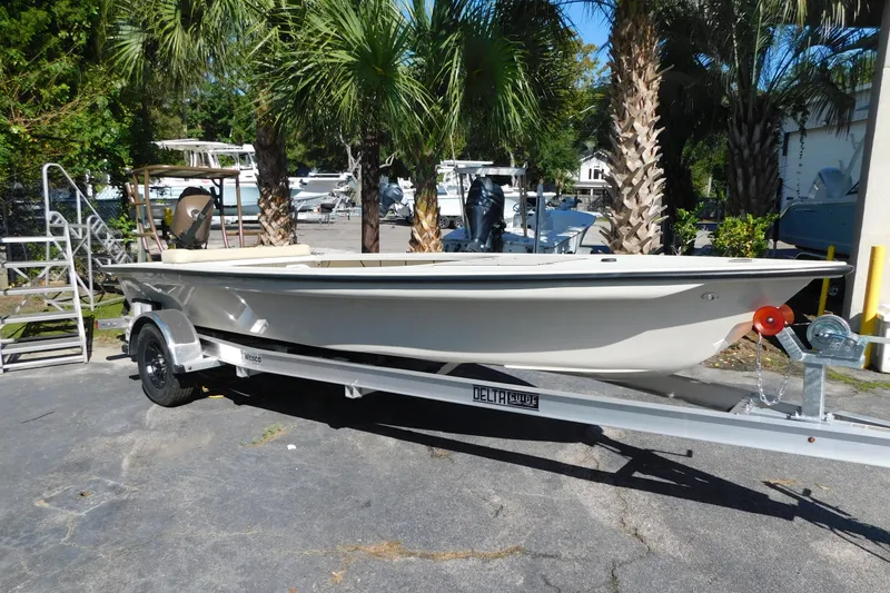 Slide: The Image of 2026 Delta Boatworks Delta D18 with Yamaha outboard motor, parked on a trailer. - 11