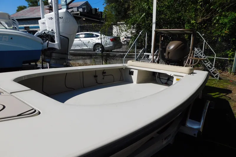 Slide: The Image of Open storage compartment of 2026 Delta D-18 Tiller boat, featuring a fuel tank and wiring. - 17