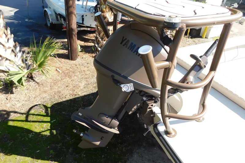 Slide: The Image of 2026 Delta Boatworks Delta D-18 Tiller in a boatyard, surrounded by other boats. - 22