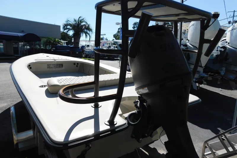 Slide: The Image of 2026 Delta D-18 Tiller boat with Yamaha outboard motor, docked near palm trees. - 23