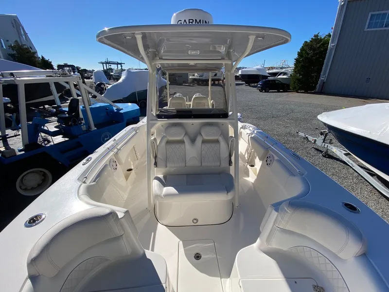 Slide: The Image of 2026 Key West 263 FS boat with spacious seating and modern design in a marina setting. - 10