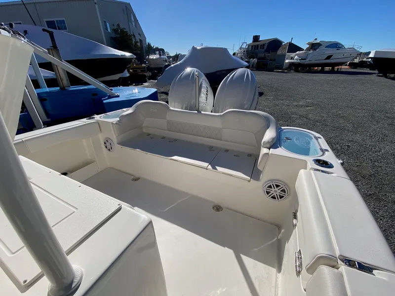 Slide: The Image of 2026 Key West 263 FS boat interior with seating and storage, docked outdoors. - 11