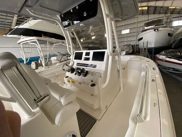 Slide: The Image of 2026 Key West 263 FS boat dashboard with steering wheel and dual displays. - 4