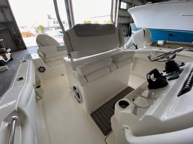Slide: The Image of 2026 Key West 263 FS boat dashboard with dual screens and overhead storage. - 5