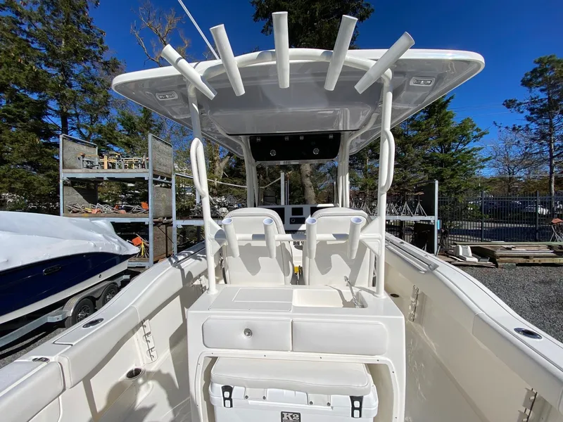 Slide: The Image of 2026 Key West 263 FS boat with T-top and rod holders, docked outdoors. - 9