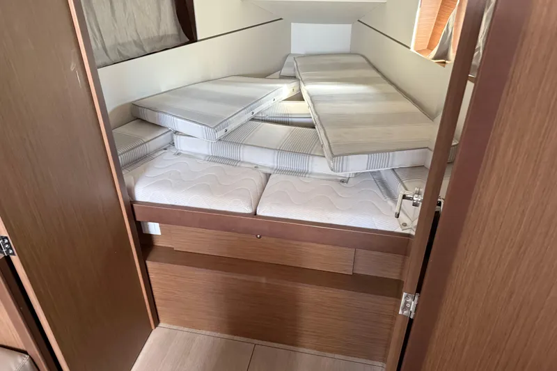 Slide: The Image of Interior cabin of 2021 Beneteau Oceanis 35.1 yacht with stacked mattresses. - 16