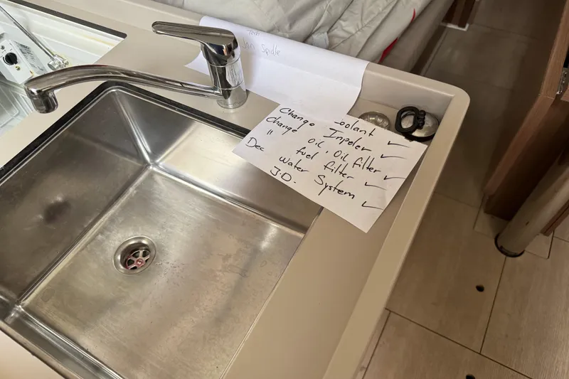 Slide: The Image of Beneteau Oceanis 35.1 yacht kitchen sink with maintenance checklist, 2021 model. - 18