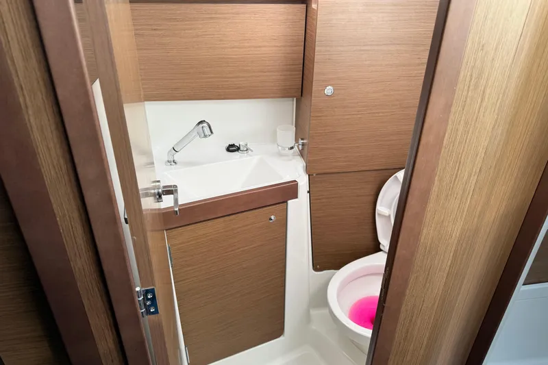 Slide: The Image of Beneteau Oceanis 35.1 2021 yacht bathroom with wooden finish and modern fixtures. - 21