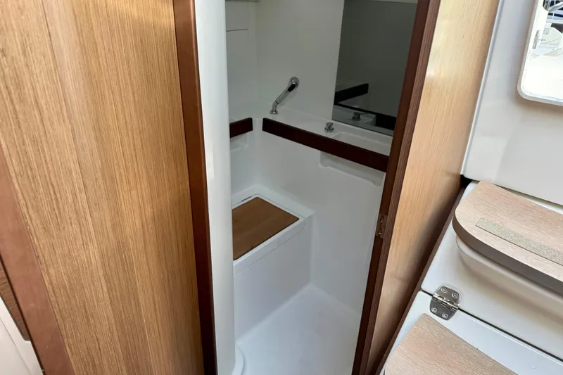 Slide: The Image of Beneteau Oceanis 35.1 2021 yacht bathroom with wooden accents and compact design. - 22