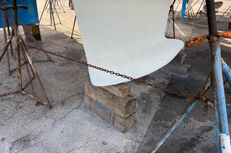 Slide: The Image of Keel of 2021 Beneteau Oceanis 35.1 sailboat supported by stands and chains. - 25