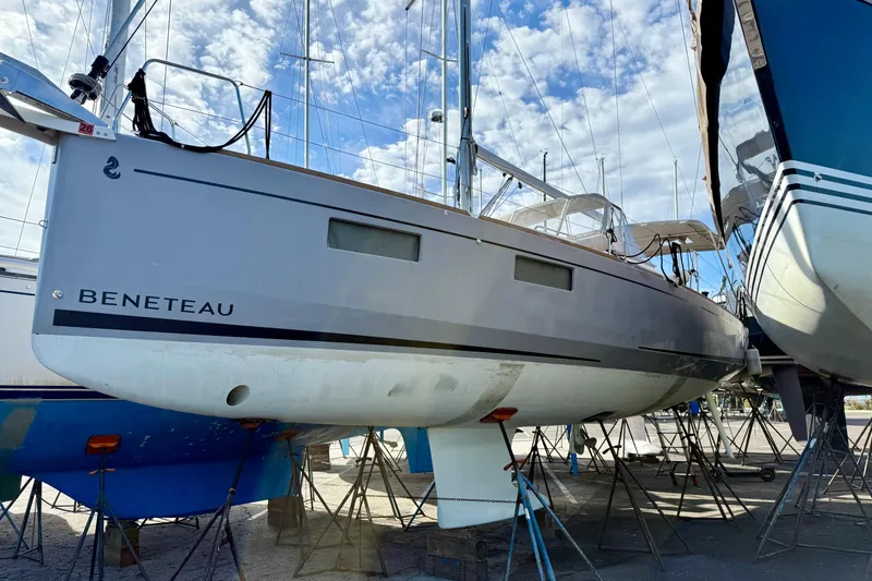 Slide: The Image of 2021 Beneteau Oceanis 35.1 sailboat on dry dock under a blue sky. - 27