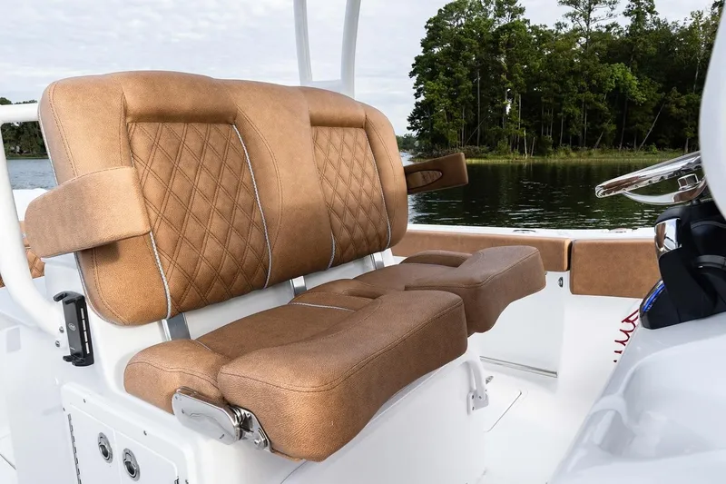Slide: The Image of 2026 Sea Hunt Ultra 285 SE boat interior with brown seating and white table. - 11