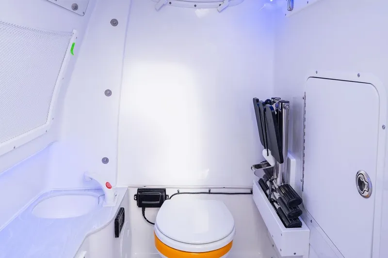 Slide: The Image of 2026 Sea Hunt Ultra 285 SE boat docked by a serene lakeside with lush trees. - 12