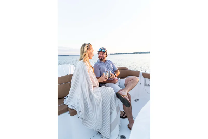 Slide: The Image of Couple enjoying a relaxing moment on a 2026 Sea Hunt Ultra 285 SE boat. - 19