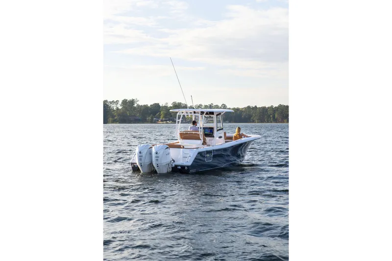 Slide: The Image of 2026 Sea Hunt Ultra 285 SE boat cruising on a serene lake. - 20