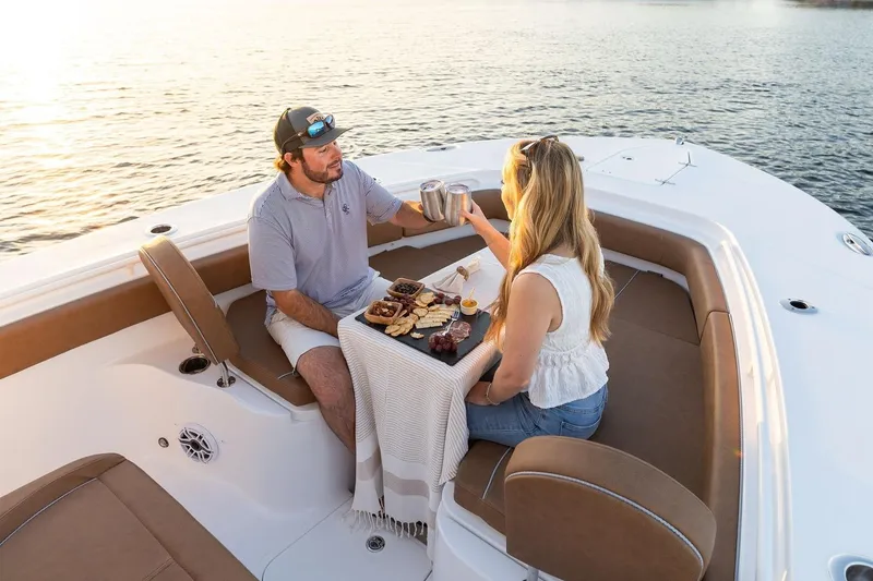 Slide: The Image of 2026 Sea Hunt Ultra 285 SE boat on calm water, surrounded by trees. - 4